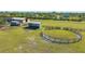 Aerial view of the expansive horse property featuring green pastures, paddocks, shelters, and well-maintained fencing at 25205 67Th E Ave, Myakka City, FL 34251