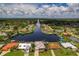 Beautiful aerial view of waterfront homes on canal with lush landscaping and access to bay at 4440 Tatum St, Port Charlotte, FL 33948