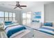 Charming bedroom with two twin beds, light blue accents, and sliding glass doors at 4440 Tatum St, Port Charlotte, FL 33948