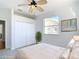 Bright bedroom featuring large closet, ceiling fan, and sunny window with a view at 4440 Tatum St, Port Charlotte, FL 33948