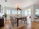 Neutral dining room features a dark wood table, upholstered chairs, and sliding glass doors at 4440 Tatum St, Port Charlotte, FL 33948