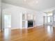 Living room featuring fireplace, built-ins, hardwood floors, and entryway to front door at 4440 Tatum St, Port Charlotte, FL 33948