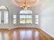 Bright living room with hardwood floors, oversized windows and doorway to front entryway at 4440 Tatum St, Port Charlotte, FL 33948