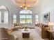 Staged living room with neutral-toned furniture, arched entry, lots of light, and a large window at 4440 Tatum St, Port Charlotte, FL 33948