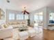 Bright living room with white sectional, plush rug, and large sliding doors to enjoy the outside view at 4440 Tatum St, Port Charlotte, FL 33948