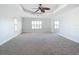 Large main bedroom with a ceiling fan and two shuttered windows at 4440 Tatum St, Port Charlotte, FL 33948