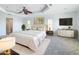 Bright main bedroom featuring a ceiling fan, white furnishings, and decorative gold accents at 4440 Tatum St, Port Charlotte, FL 33948