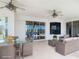 Cozy covered patio with wicker dining and lounge furniture, offering scenic views at 4440 Tatum St, Port Charlotte, FL 33948