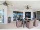 Beautiful covered patio featuring a ceiling fan, waterfront views, and a wicker dining set at 4440 Tatum St, Port Charlotte, FL 33948