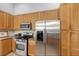 Modern kitchen with stainless steel appliances and wood cabinets at 6836 Bay Hill Dr, Bradenton, FL 34202