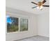 Bright bedroom with gray vinyl flooring and a ceiling fan at 7555 Hanchey St, North Port, FL 34287