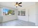 Spacious living room with wood-look floors and large windows at 7555 Hanchey St, North Port, FL 34287