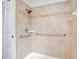 Accessible shower with grab bars and tiled walls at 7555 Hanchey St, North Port, FL 34287