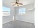 Bedroom with grey carpet, double closet, and ceiling fan with pool view at 4440 Tatum St, Port Charlotte, FL 33948