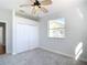 Bedroom with grey carpet, double closet, and ceiling fan at 4440 Tatum St, Port Charlotte, FL 33948