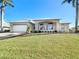 Inviting exterior of a two-story home with a well-maintained lawn at 4440 Tatum St, Port Charlotte, FL 33948