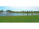 Community lake with fountain and homes in the background at 16721 Barnwood Pl, Bradenton, FL 34211