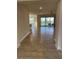 Bright entryway with tile flooring leading to the living room and patio at 16721 Barnwood Pl, Bradenton, FL 34211