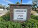 Find your way with this clear clubhouse sign at 4502, surrounded by blooming flowers and greenery at 4320 47Th W Ave # 203, Bradenton, FL 34210