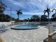 Enjoy the beautiful community pool, surrounded by lounge chairs and lush palm trees under a bright sky at 4320 47Th W Ave # 203, Bradenton, FL 34210