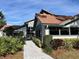 Striking building exterior with a red tile roof and lush landscaping, offering a welcoming entrance at 4320 47Th W Ave # 203, Bradenton, FL 34210