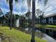 A serene pond view with a fountain surrounded by lush greenery and community buildings under a blue sky at 4320 47Th W Ave # 203, Bradenton, FL 34210