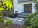 Backyard with stone pavers, lush landscaping, and exterior view of the house at 5373 Dominica Cir, Sarasota, FL 34233