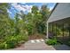 Backyard with lush tropical landscaping and view of the home's screened porch at 5373 Dominica Cir, Sarasota, FL 34233