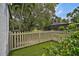 Backyard area with white picket fence and lush green lawn at 5373 Dominica Cir, Sarasota, FL 34233