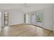 Bright and airy bedroom with light wood floors, multiple windows, and a ceiling fan at 5373 Dominica Cir, Sarasota, FL 34233