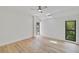 Bright bedroom with wood floors, skylight, and a view of lush greenery from the windows at 5373 Dominica Cir, Sarasota, FL 34233