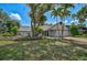 Well-manicured front yard with mature landscaping and palm trees at 5373 Dominica Cir, Sarasota, FL 34233