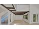 Bright living room with wood floors, high ceilings, exposed beams, and large windows at 5373 Dominica Cir, Sarasota, FL 34233