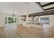 Open-concept living space featuring wood floors, a built-in bench, and a modern kitchen at 5373 Dominica Cir, Sarasota, FL 34233