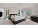 Sunlit main bedroom with neutral tones, a ceiling fan, and private access to an outdoor patio at 5373 Dominica Cir, Sarasota, FL 34233