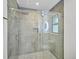 Modern bathroom shower with glass door, pebble floor, and sleek fixtures at 5373 Dominica Cir, Sarasota, FL 34233