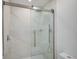 Elegant glass shower with marble tile and rain shower head at 5373 Dominica Cir, Sarasota, FL 34233