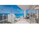 Spacious balcony with outdoor furniture and breathtaking water views at 555 Quay Cmn # 705, Sarasota, FL 34236