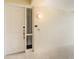 White front door with sidelight and security system at 7840 34Th W Ave # 103, Bradenton, FL 34209