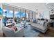 Modern living room featuring a comfy sectional sofa and city views at 1155 N Gulfstream Ave # 703, Sarasota, FL 34236