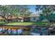 House back view, overlooking a canal with lush landscaping at 128 51St Street E Cir # 7, Palmetto, FL 34221