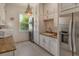 Bright laundry room with granite counters and stainless steel appliances at 2412 Bay Dr W Ave, Bradenton, FL 34207