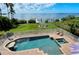 Inviting pool and spa with a fire pit and lounge chairs at 2412 Bay Dr W Ave, Bradenton, FL 34207