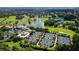 Aerial view of a community with manicured tennis courts, beautiful landscaping, a lake, and lush golf course at 401 Walls Way, Osprey, FL 34229