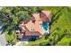 An aerial view of a stunning property featuring a tile roof, swimming pool, and verdant surroundings at 401 Walls Way, Osprey, FL 34229