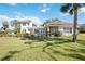 Expansive backyard featuring a well-maintained lawn and mature trees, perfect for outdoor activities at 401 Walls Way, Osprey, FL 34229