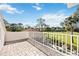 Relaxing balcony area featuring brick flooring and a serene view of the golf course and lush greenery at 401 Walls Way, Osprey, FL 34229