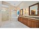 Elegant bathroom with dual vanities, garden tub, glass shower, and tiled floors at 401 Walls Way, Osprey, FL 34229