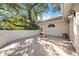 Charming courtyard featuring a decorative fountain, potted plants, and a tiled patio at 401 Walls Way, Osprey, FL 34229