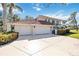 Exterior view of a spacious home featuring a three-car garage and manicured landscaping at 401 Walls Way, Osprey, FL 34229